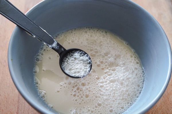 Active dry yeast being stirred into warm water